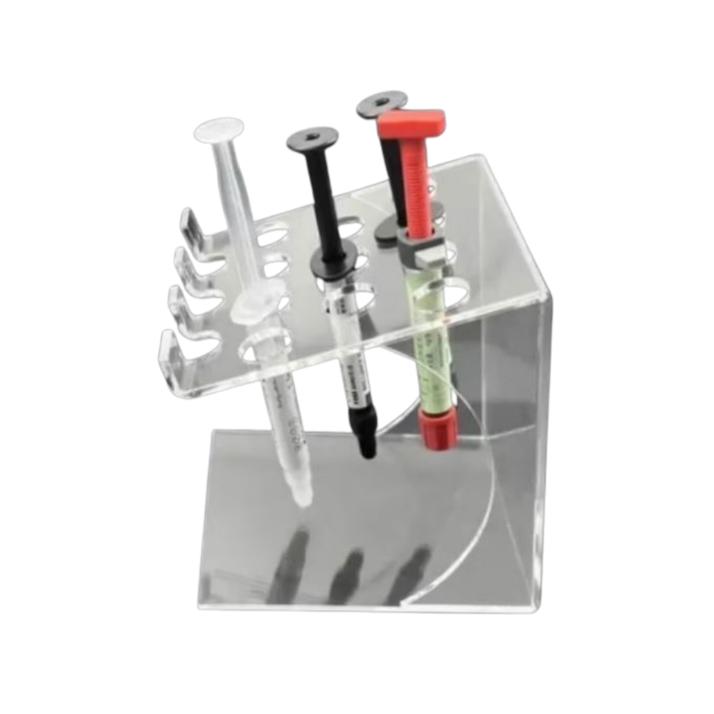 A clear acrylic syringe stand holding several medical-style syringes, shown on a plain white background.